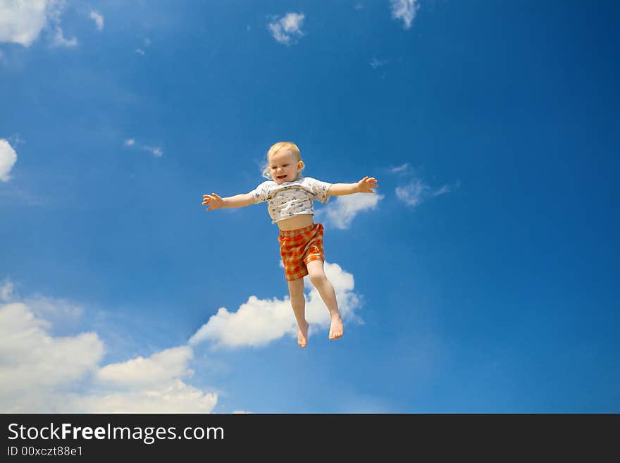 Happy small girl fly in the blue sky. Happy small girl fly in the blue sky