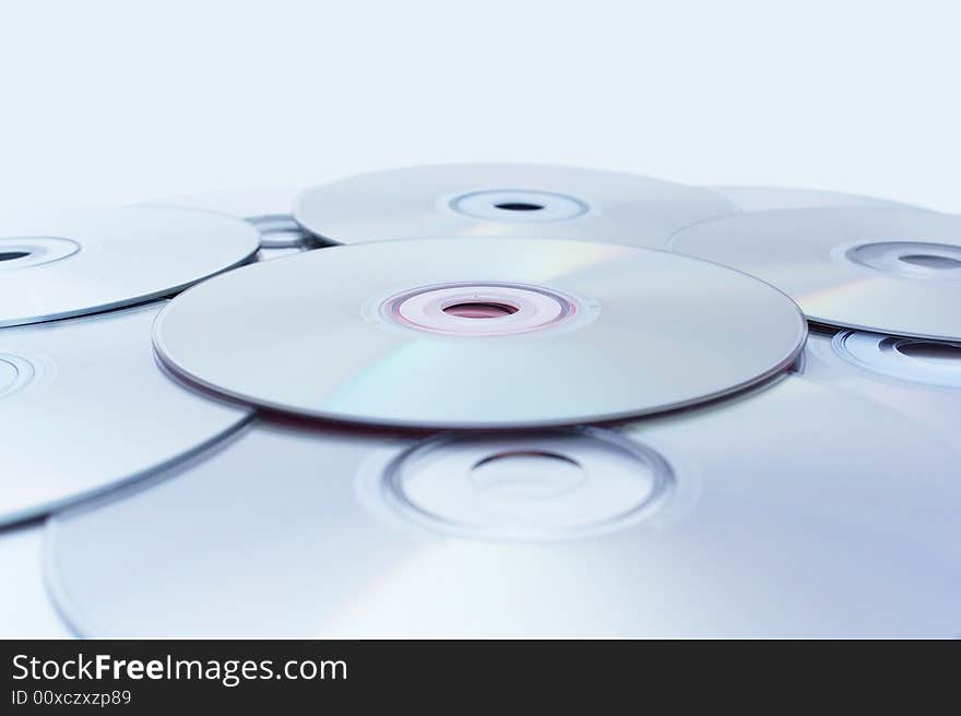 Stack of CDs on light blue background.