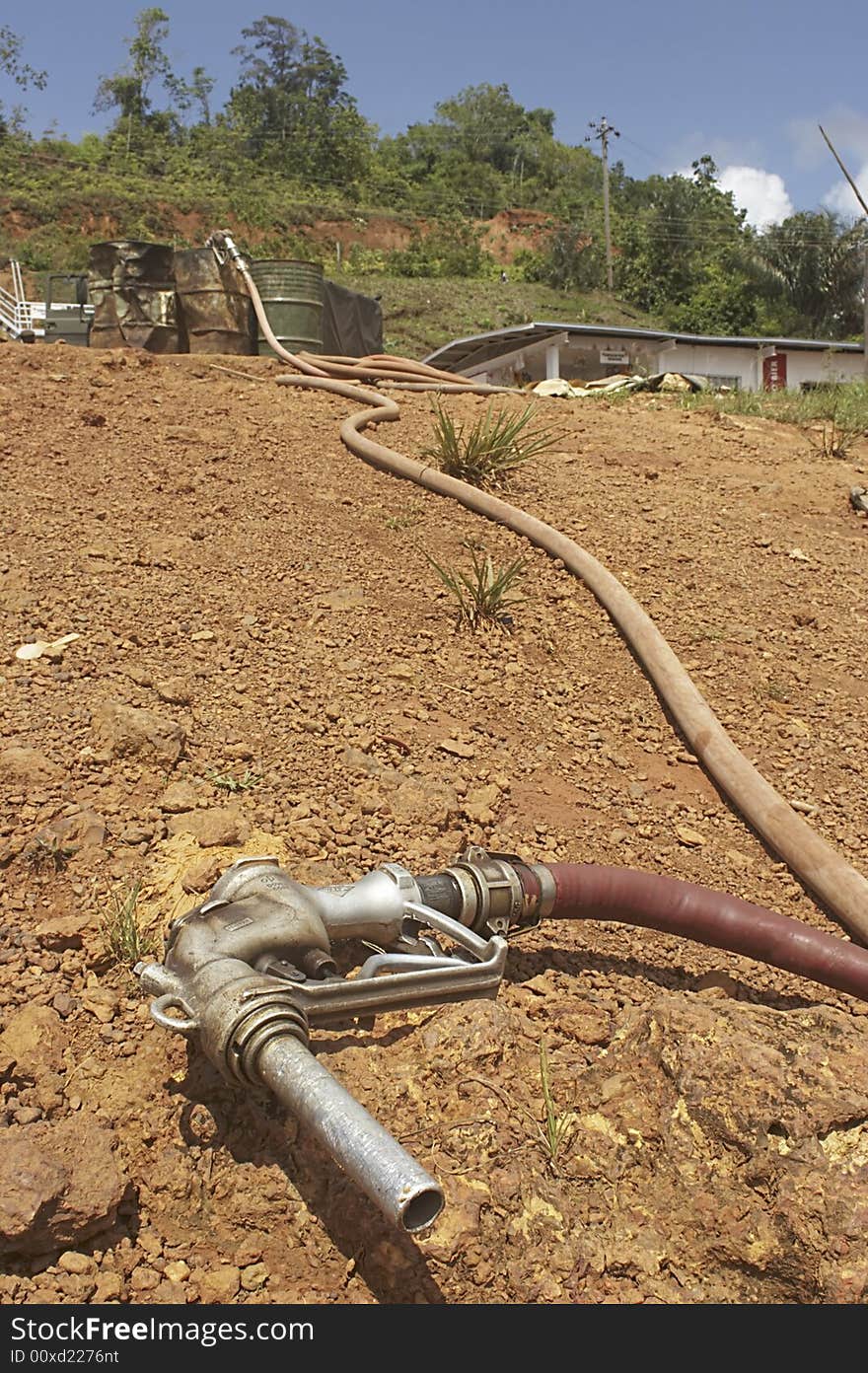 Gasoline filling hose lying on the beach in the port town of Affobaka on the Brokopondo reservoir, Suriname. Gasoline filling hose lying on the beach in the port town of Affobaka on the Brokopondo reservoir, Suriname.