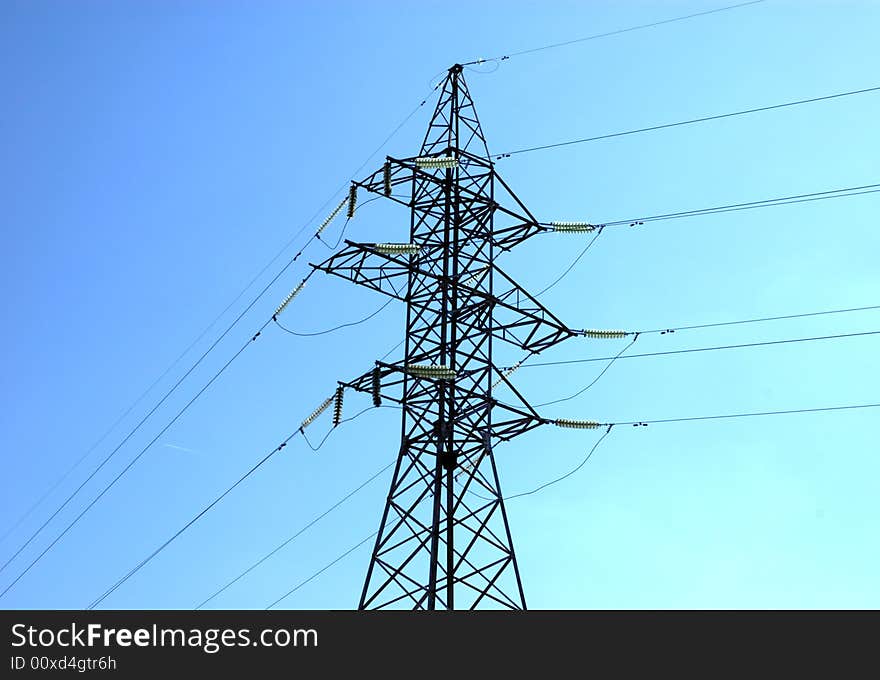 High volts power line on blue sky with insulators and wires. High volts power line on blue sky with insulators and wires