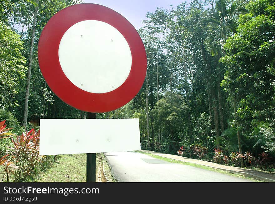 Blank / empty road sign with trees along the road. Blank / empty road sign with trees along the road