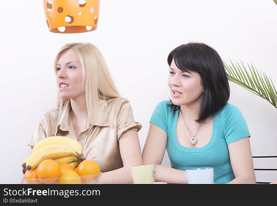 Two girls having brainstorm while drinking coffee. Two girls having brainstorm while drinking coffee