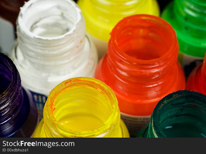 Opened paint buckets with various colours