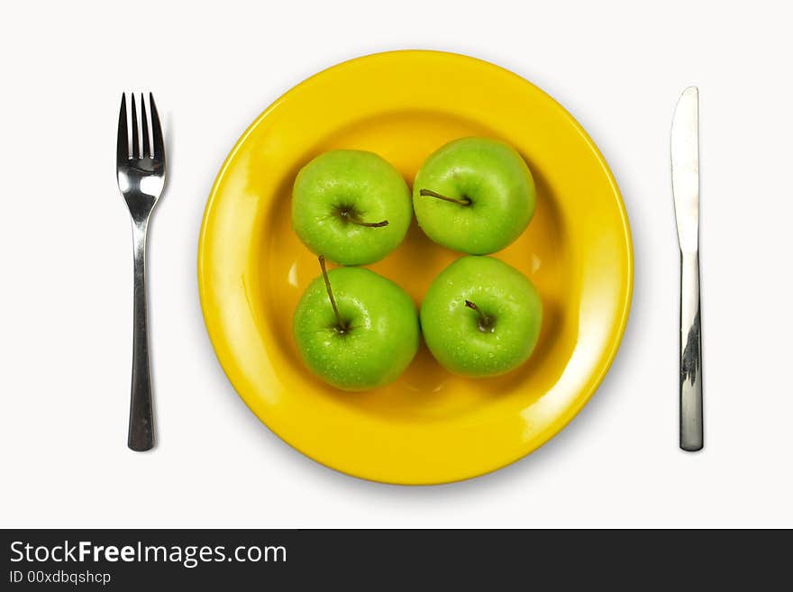 Green apples on with plate with fork and knife. Green apples on with plate with fork and knife