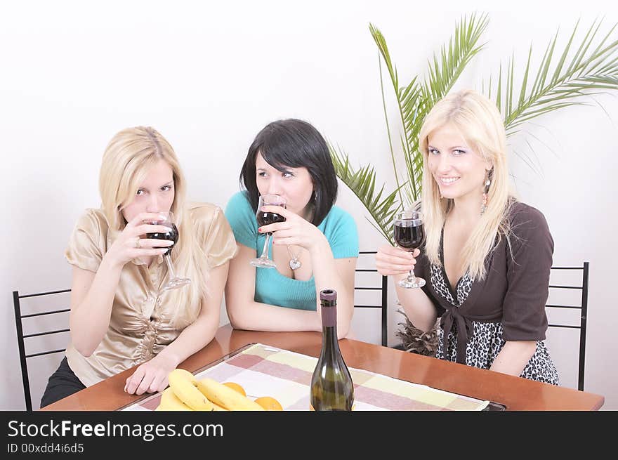 Three girlfriends drinking wine and having fun