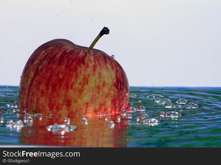 Fresh apple in the bubbling water, a fresh and healthy dessert in the summer