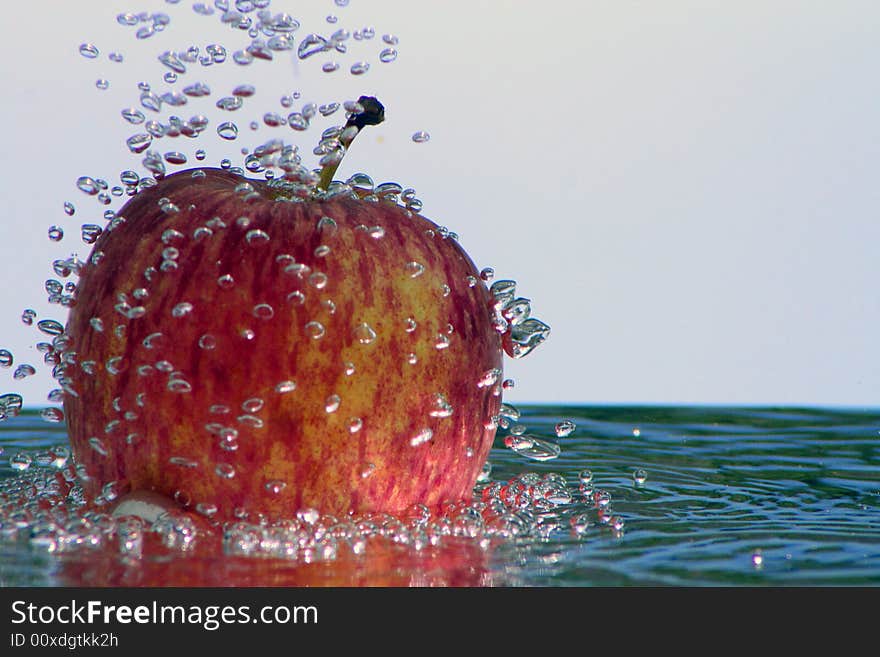 Fresh apple in the bubbling water, a fresh and healthy dessert in the summer