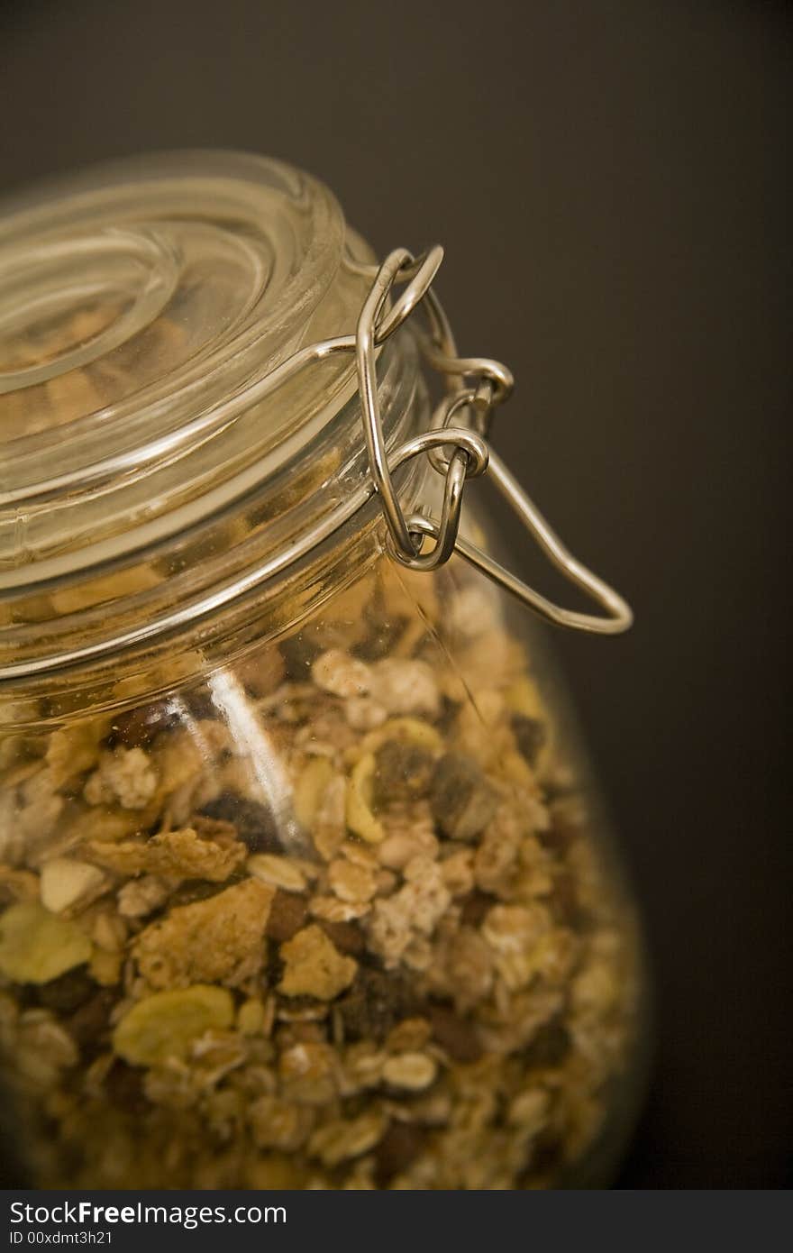 Corn flakes in glass on dark background