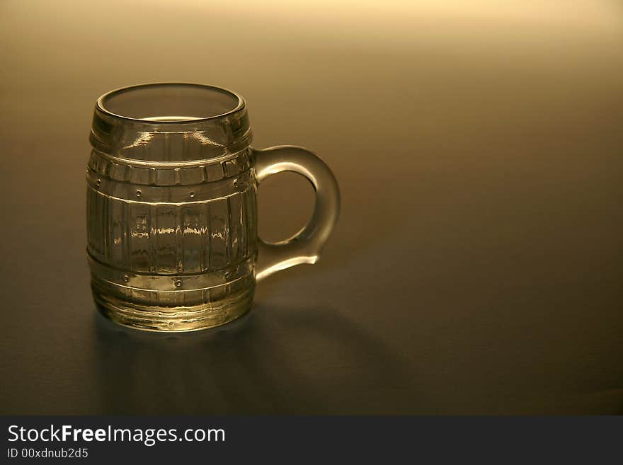 Empty small bear glass on brown background