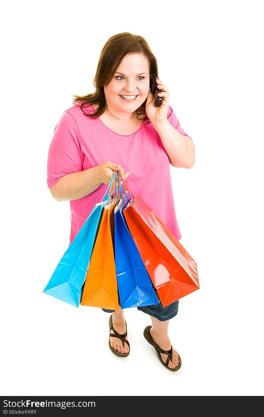 Pretty plus-sized woman holding her shopping bags and talking on the phone. Full body isolated on white. Pretty plus-sized woman holding her shopping bags and talking on the phone. Full body isolated on white.