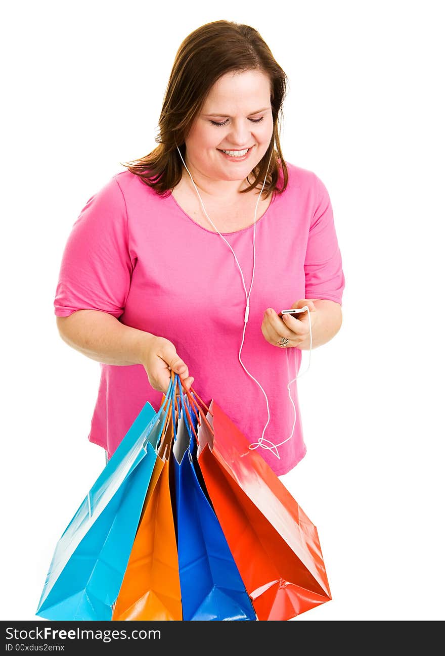 Pretty plus-sized woman holding her shopping bags and listening to music.  Isolated on white. Pretty plus-sized woman holding her shopping bags and listening to music.  Isolated on white.