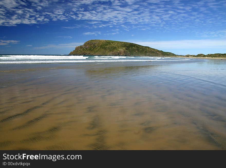 Low tide is coming in Cannibal Bay. Wide angle shot of Catlins shore. South Island. New Zealand. Low tide is coming in Cannibal Bay. Wide angle shot of Catlins shore. South Island. New Zealand