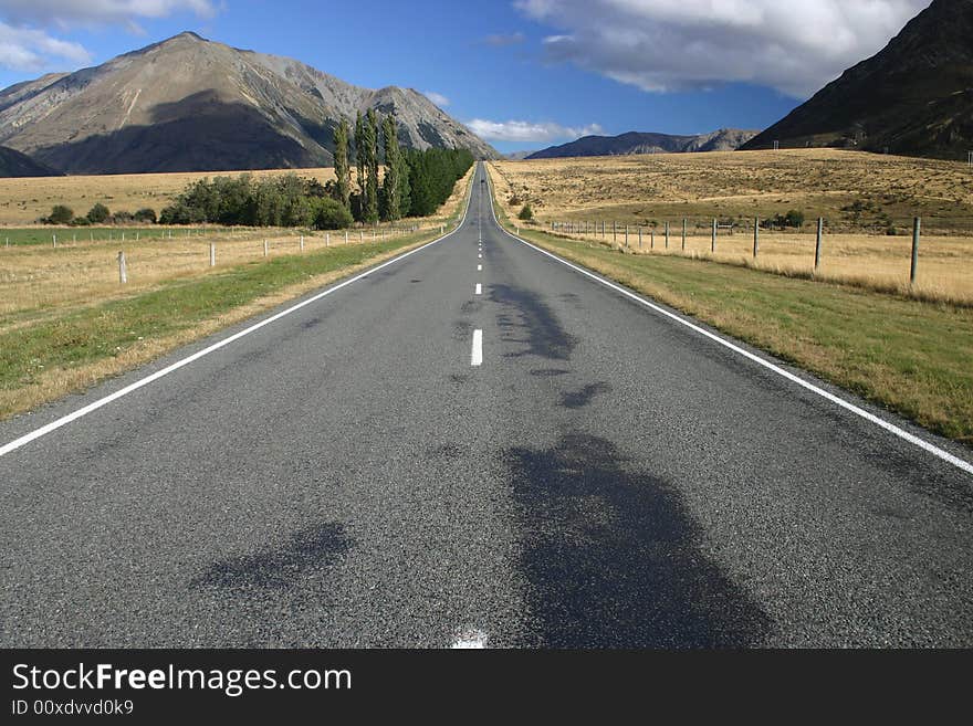 Bright sunlight with cloudscape over the scenic road in the South Island. New Zealand