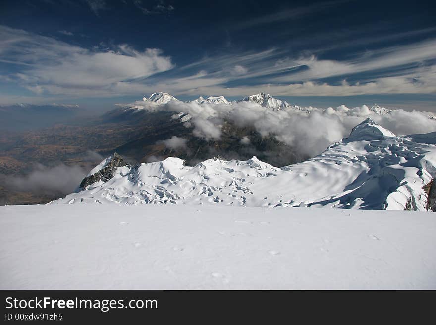 View from top of mountain Vallunaraju (5.686 m), in background Huascaran, Andes, Peru. View from top of mountain Vallunaraju (5.686 m), in background Huascaran, Andes, Peru