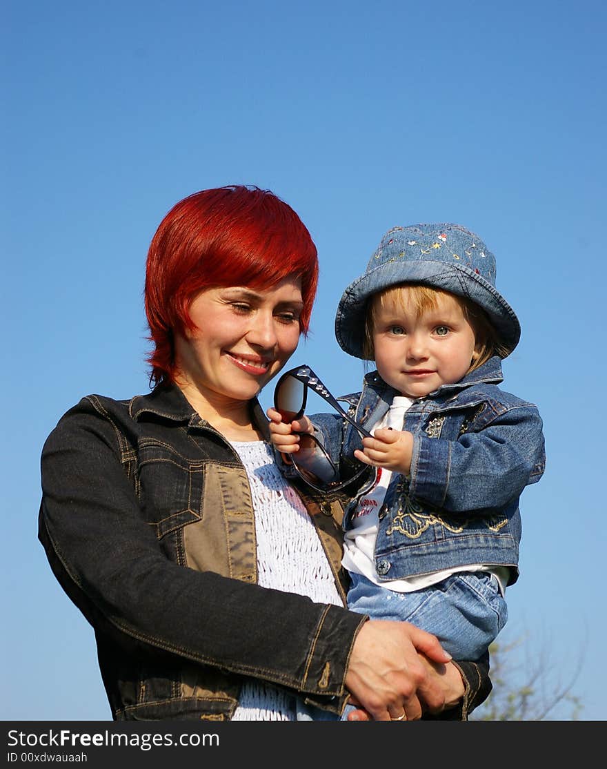 The little girl and her mum on a grass