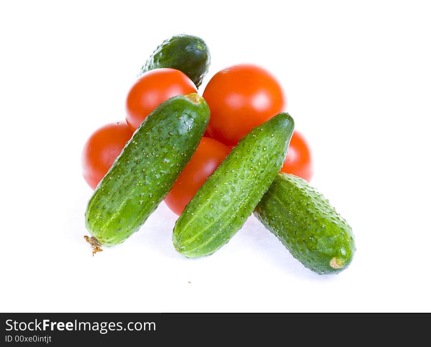 Tomatoes and cucumbers isolated on white