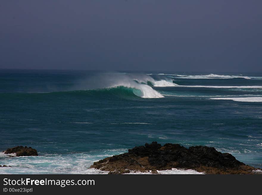 Huge wave breaking in off shore wind. Huge wave breaking in off shore wind