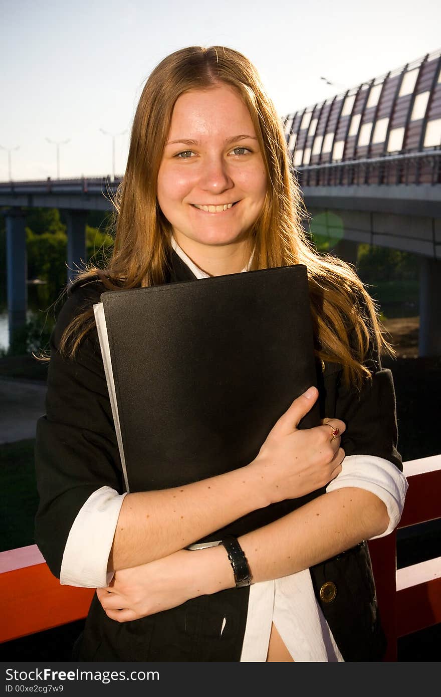 The young attractive businesswoman with a folder. The young attractive businesswoman with a folder