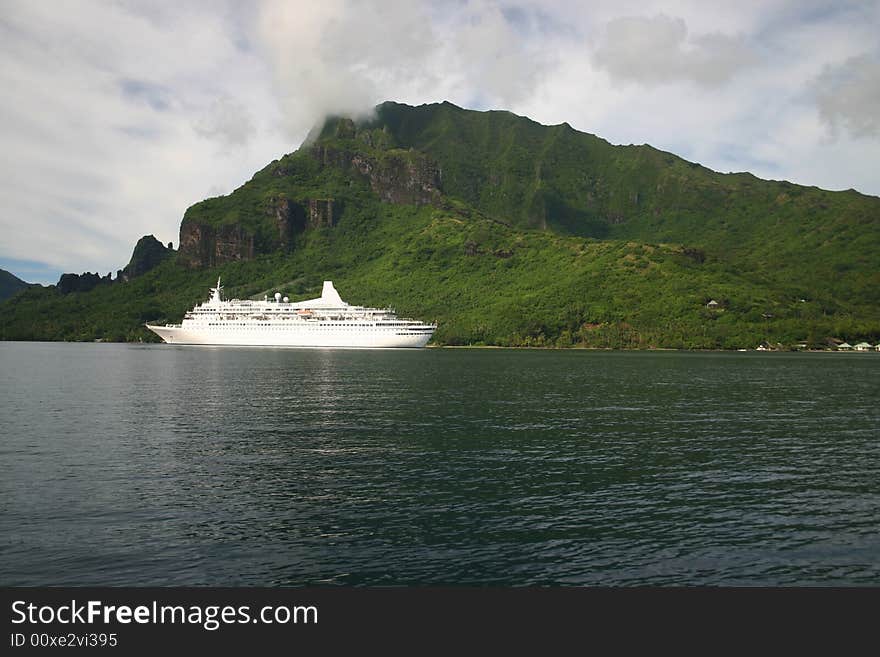 Modern cruise ship approaching port on Island Moorea. French Polynesia