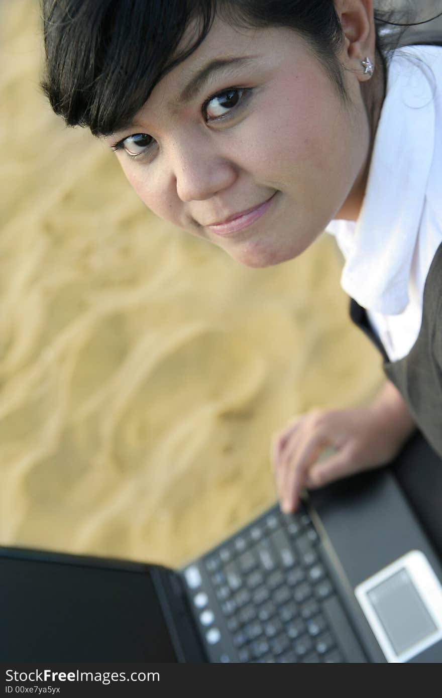 Asian business woman on the beach sand