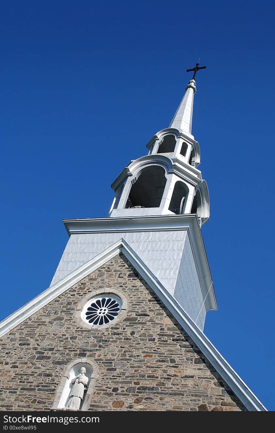 Gable old stone church with bells