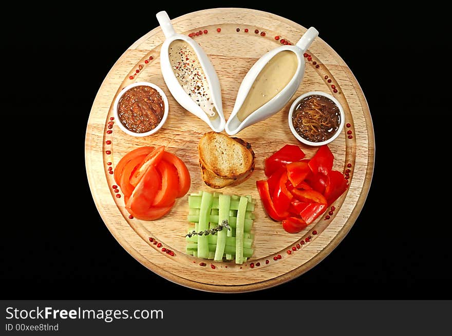 Sauce, tomato and pepper on a wooden support