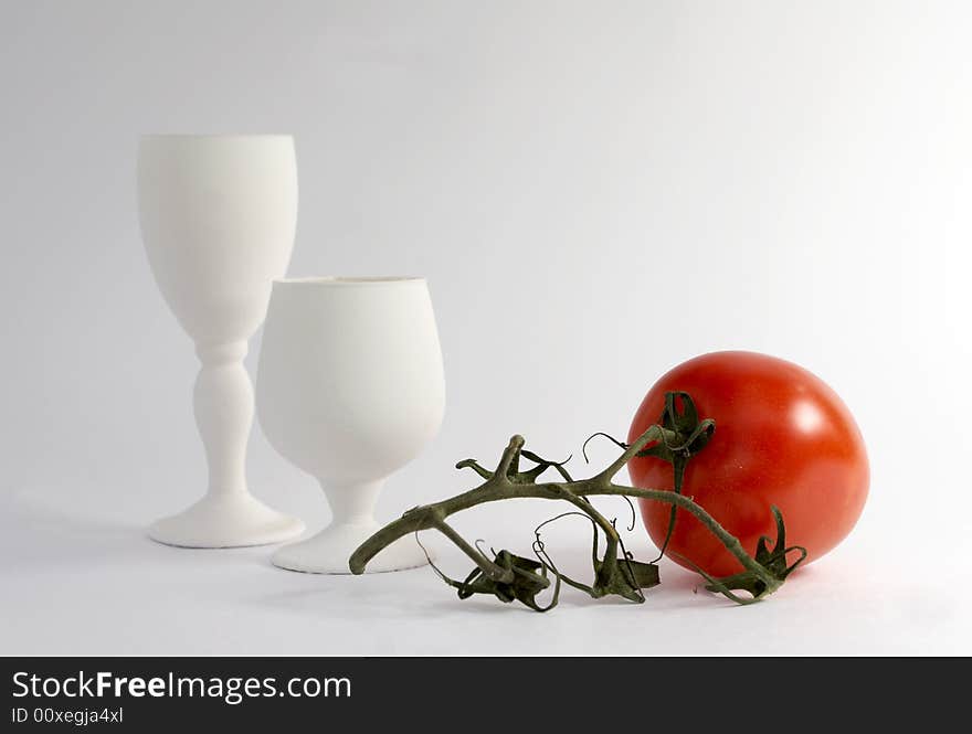 The White glasses and red tomato