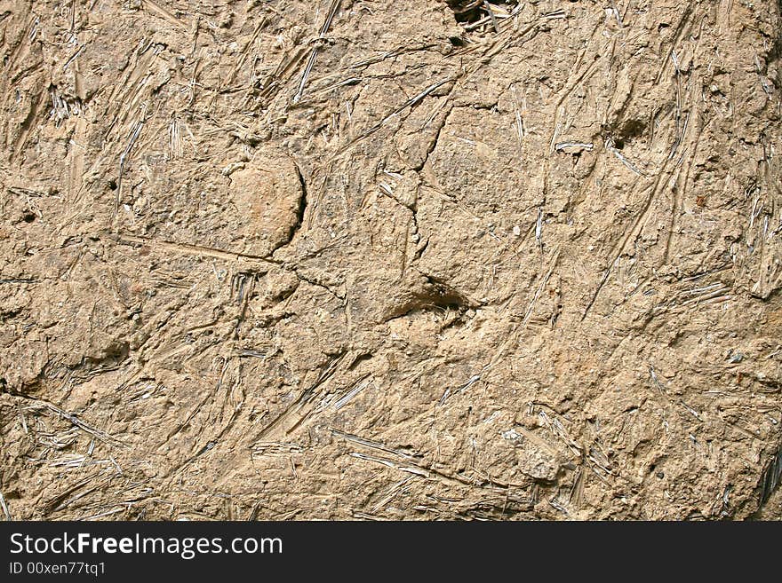 An old clay house wall. An old clay house wall