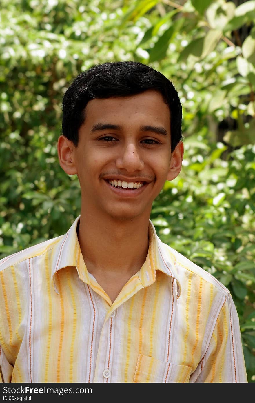 A simple Indian boy smiling happily. A simple Indian boy smiling happily.