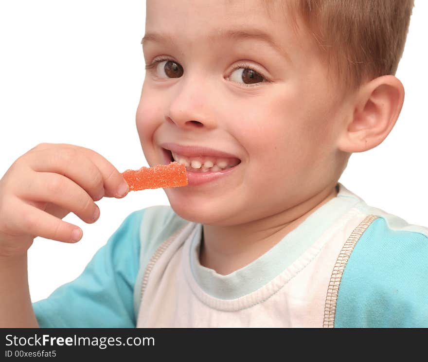 The Boy Eats Fruit Candy On A White Background