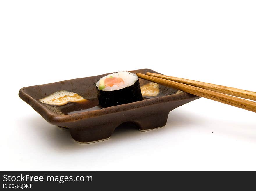 Salmon Roll With Avocado On Plate With Chopsticks