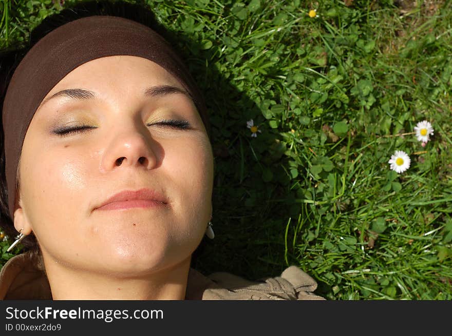 Attractive woman relaxing on green grass. Attractive woman relaxing on green grass