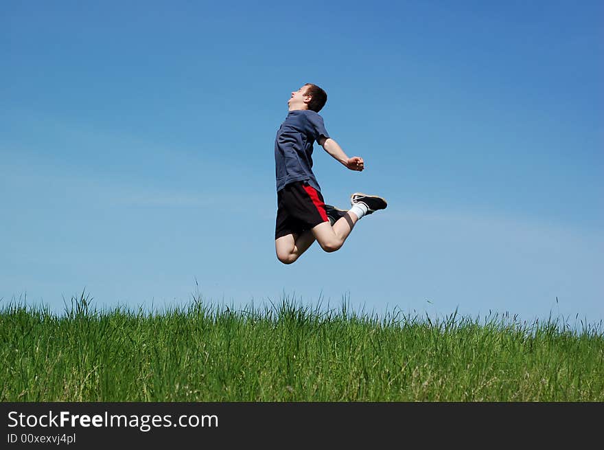 Happy jumping kid on sky background