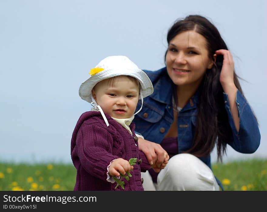 Mother and baby girl on green meadow. Mother and baby girl on green meadow