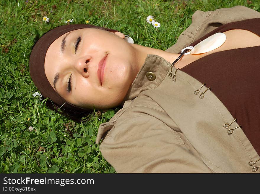 Attractive woman relaxing on green grass. Attractive woman relaxing on green grass