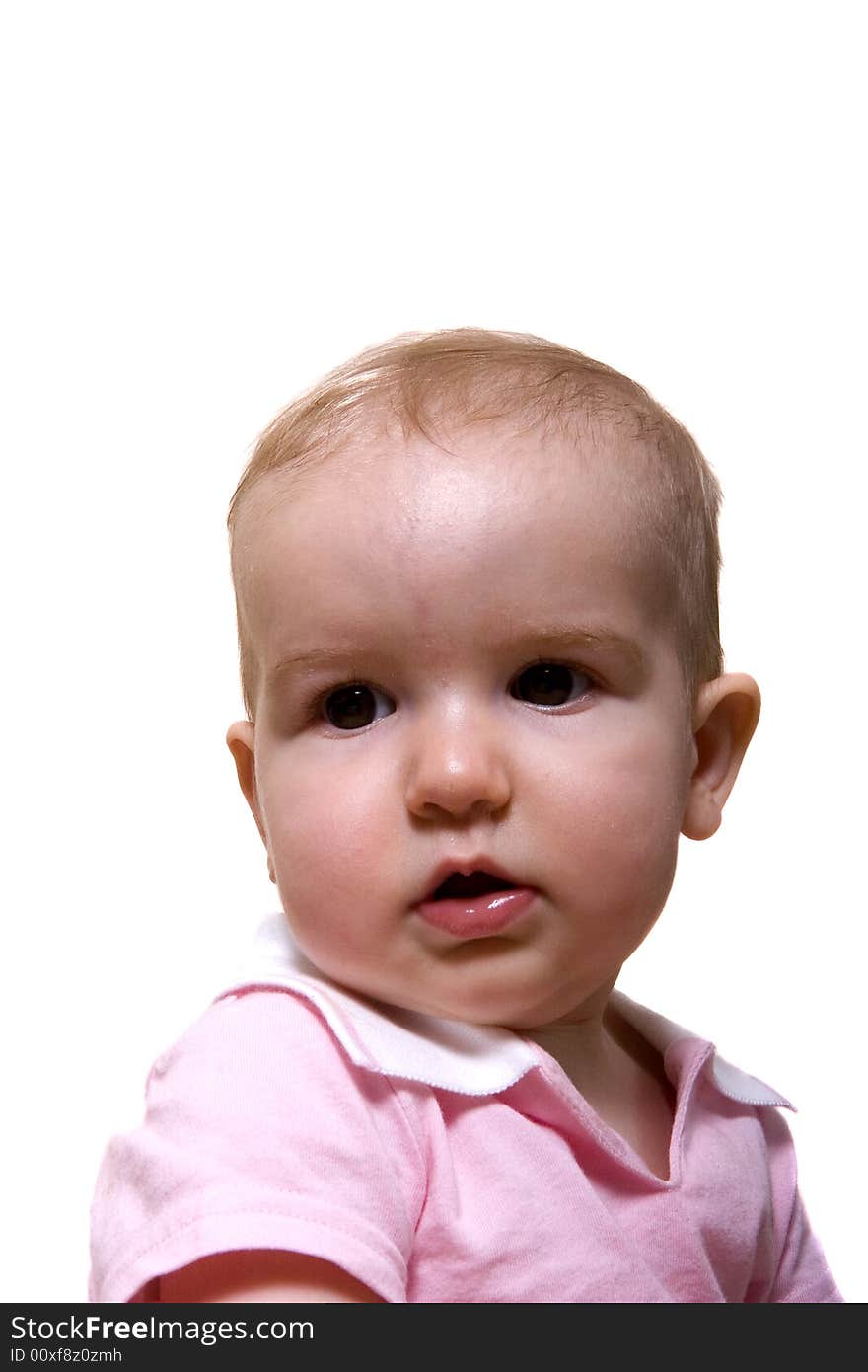 A young baby in pink on a white background. A young baby in pink on a white background