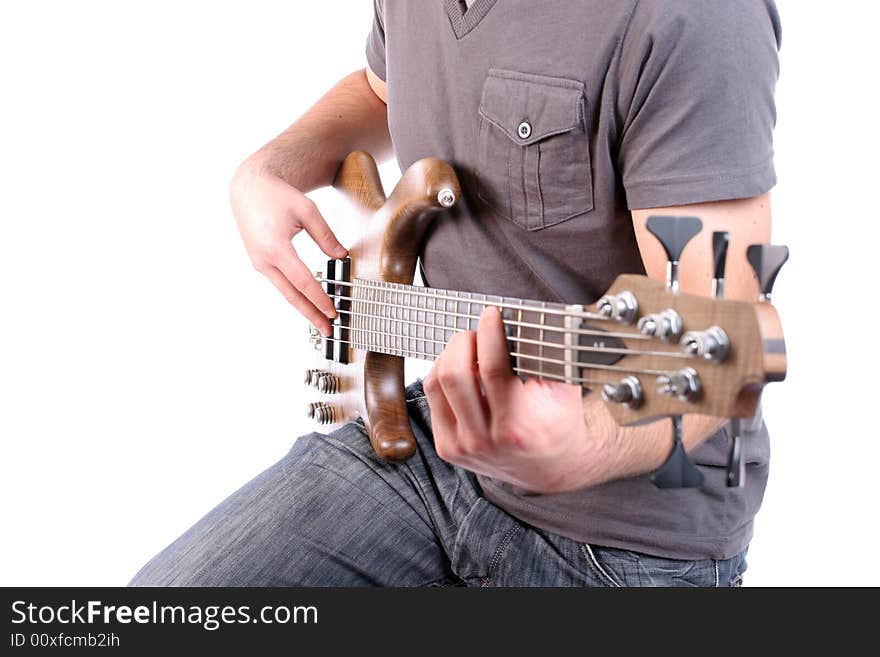 Detail of a man playing bass - focus on man's right hand