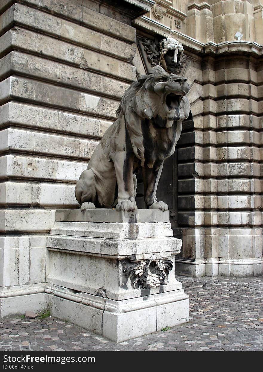 Statue of stone lion guarding the entrance into the Budapest castle. Statue of stone lion guarding the entrance into the Budapest castle