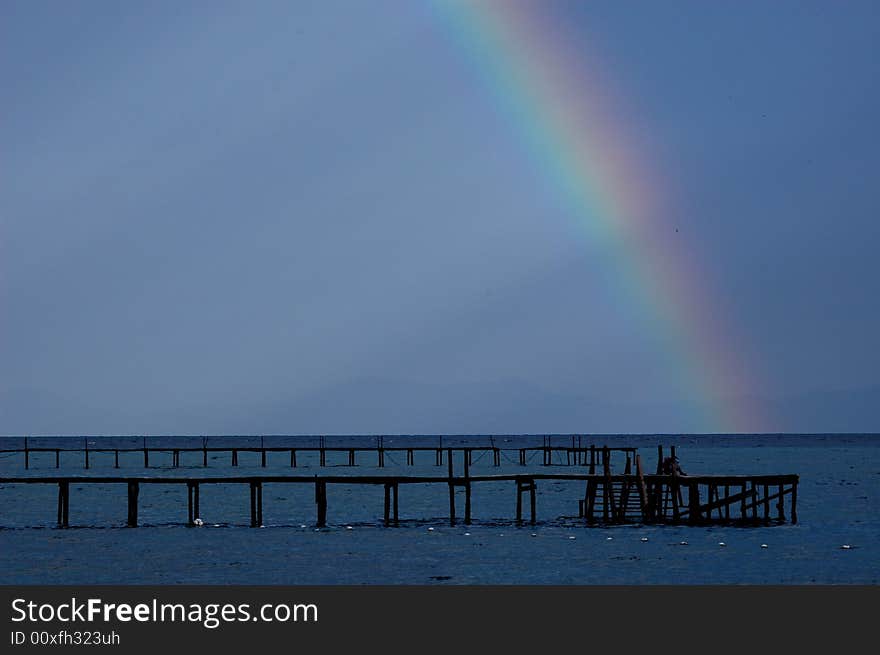 After a brief shower, a colorfull rainbow
surfaced and break the sky into two partition