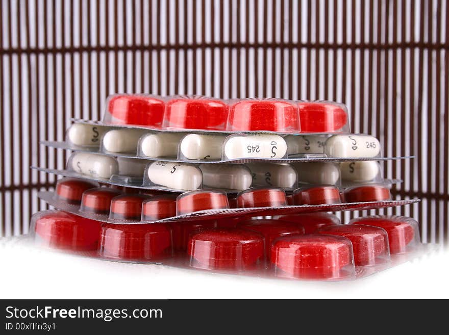 A red nd white  pile of medicines. A red nd white  pile of medicines