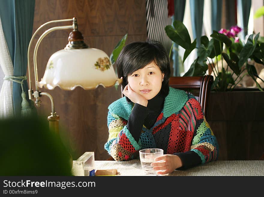 A beautiful young woman holding a cup of hot drink