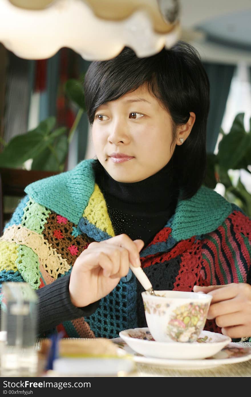 Beautiful young woman holding a cup of hot drink