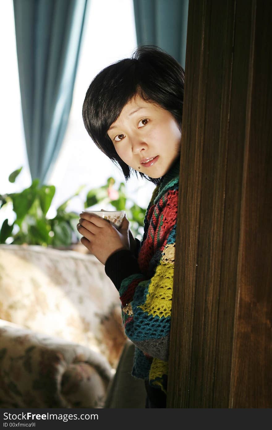 Beautiful Young Woman Holding A Cup Of Hot Drink