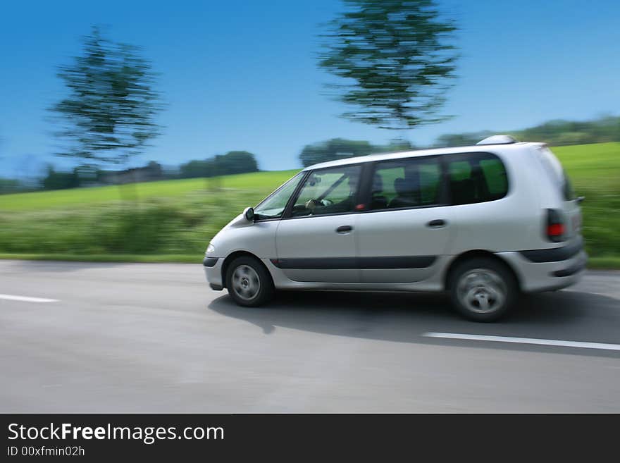 Fast car on the road with green background