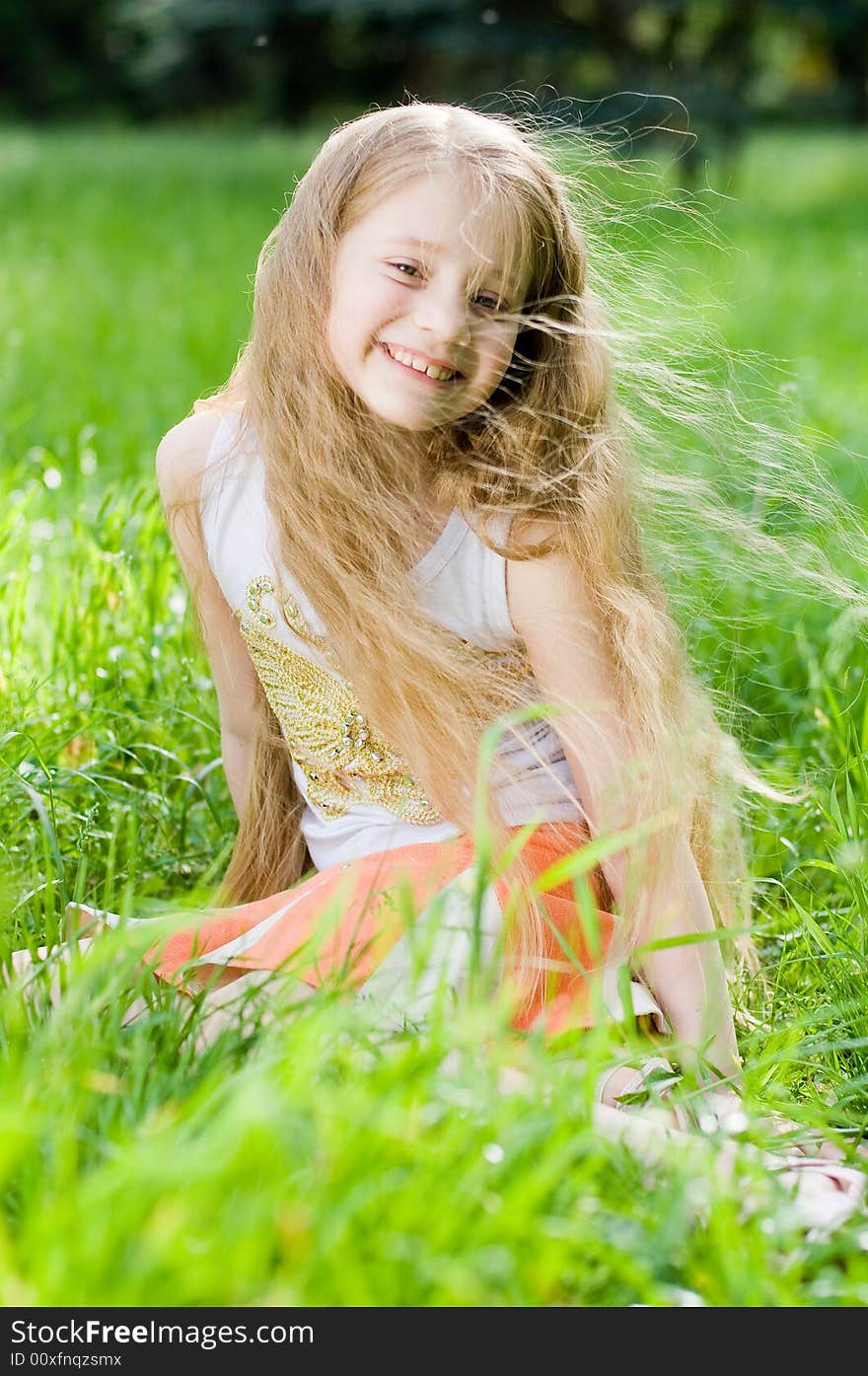 Little girl in perfect green grass, focus on face