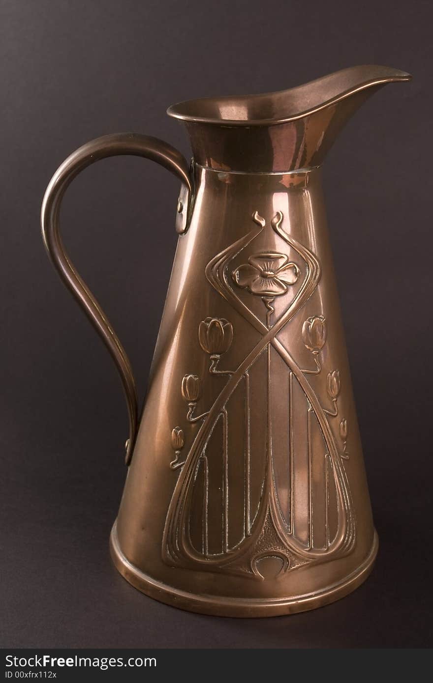 Traditional old brass jug on dark background. Traditional old brass jug on dark background