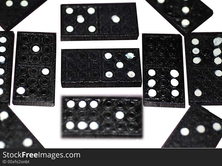 A photograph of a variety of different numbers of spots on dominoes blocks. A photograph of a variety of different numbers of spots on dominoes blocks