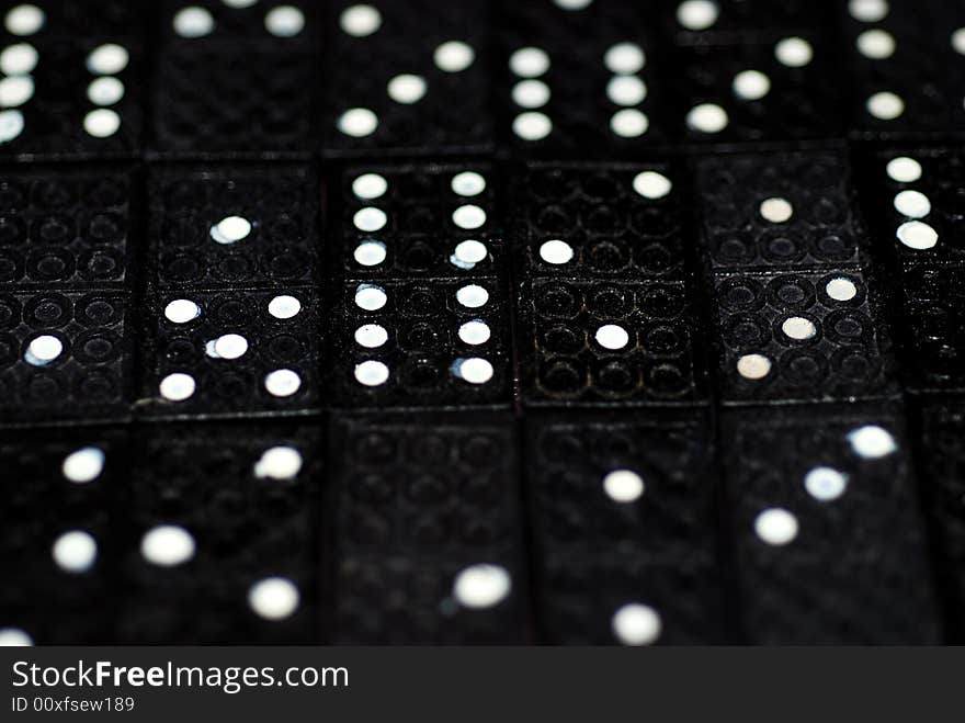 A photograph of rows of domino tiles with splodgy pips on display. A photograph of rows of domino tiles with splodgy pips on display