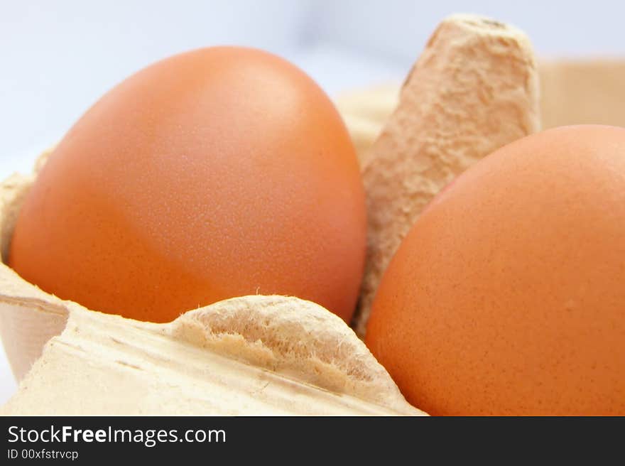 Fresh healthy brown eggs in a cardboard egg holder. Fresh healthy brown eggs in a cardboard egg holder