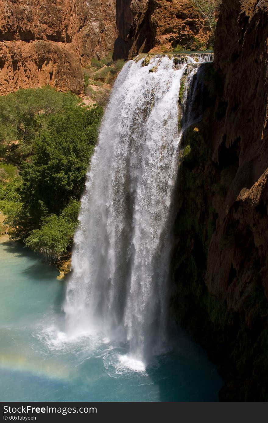 The stunning Havasu waterfall carves its way through the canyon's landscape offering a refreshing oasis from the desert's heat.